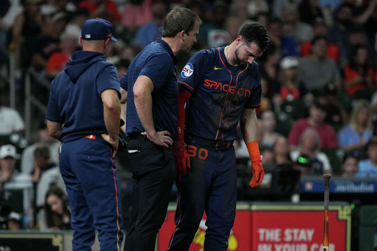 Houston Astros right fielder Kyle Tucker (30) is helped by staff after fouling a ball off himself during the third inning of an MLB game Monday, June 3, 2024, at Minute Maid Park in Houston.