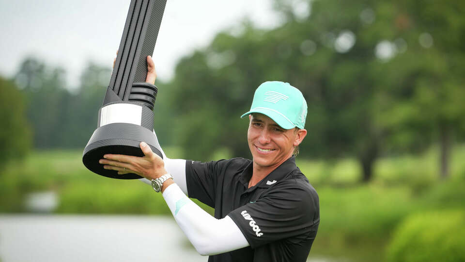 Carlos Ortiz poses for a photo with the championship trophy after winning the round of LIV Golf Houston 2024 tournament Sunday, June 9, 2024, at the Golf Club of Houston in Humble.