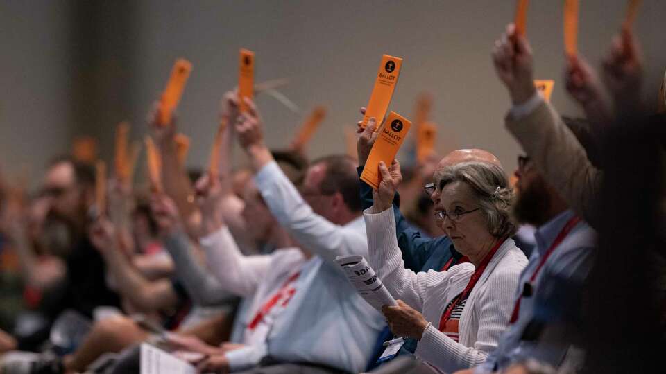 Messengers raise their ballots in support of a motion put up for vote during a Southern Baptist Convention annual meeting Tuesday, June 11, 2024, in Indianapolis.