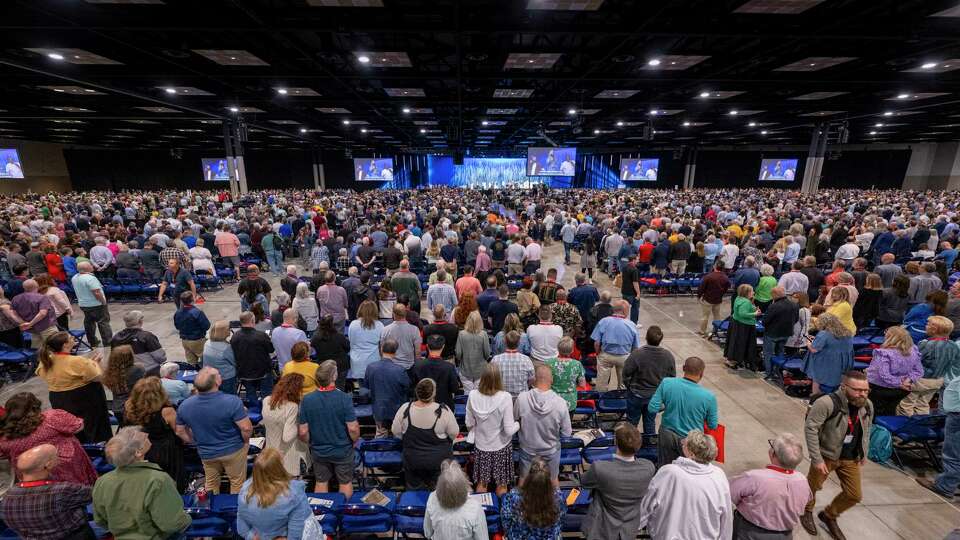 Messengers stand for worship during a Southern Baptist Convention annual meeting Tuesday, June 11, 2024, in Indianapolis.