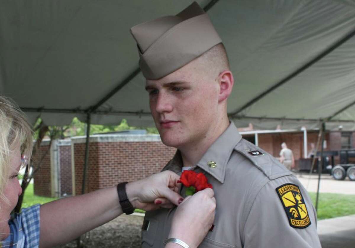 Tanner Ferris receives a red carnation after completing his freshman year at Texas A&M. Photo courtesy of George Ferris
