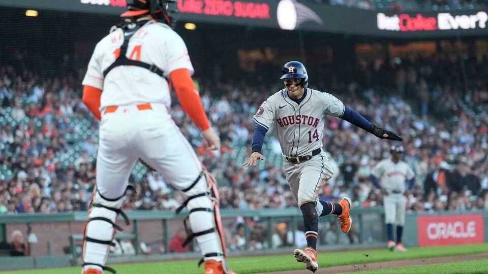 Houston Astros' Mauricio Dubón, right, runs home to score as San Francisco Giants catcher Patrick Bailey waits at the plate during the third inning of a baseball game in San Francisco, Tuesday, June 11, 2024. (AP Photo/Jeff Chiu)