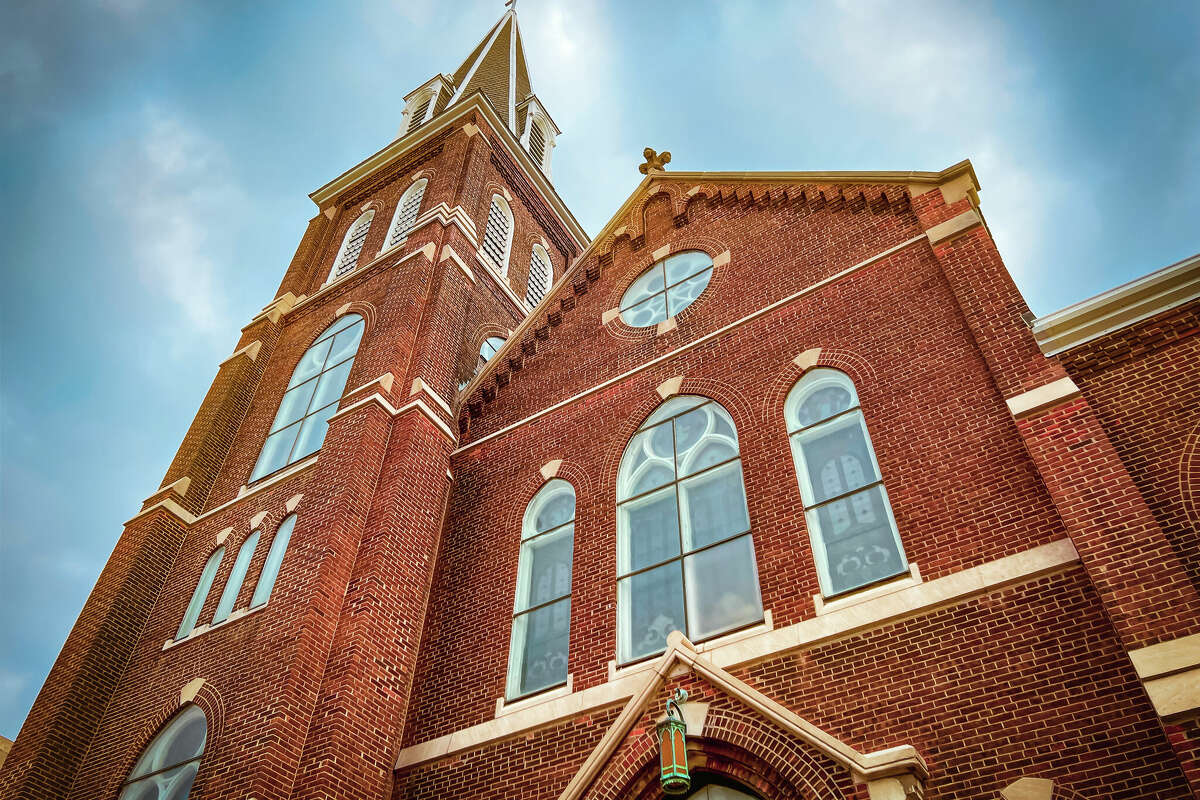 A majestic ornate old church stands tall against a dramatic blue sky. 