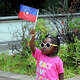 Milan Campbell proudly holds up a Juneteenth flag during Stamford city's Juneteenth celebration at the Stamford Government Center in Stamford, Conn., on Saturday June 17, 2023. Carmen Hughes, the Stamford Director of Diversity, Equity and Inclusion, organized the event, which included dozens of vendors, activist organizations, crafts for kids to make, free food, gifts, musical performances and local politicians.