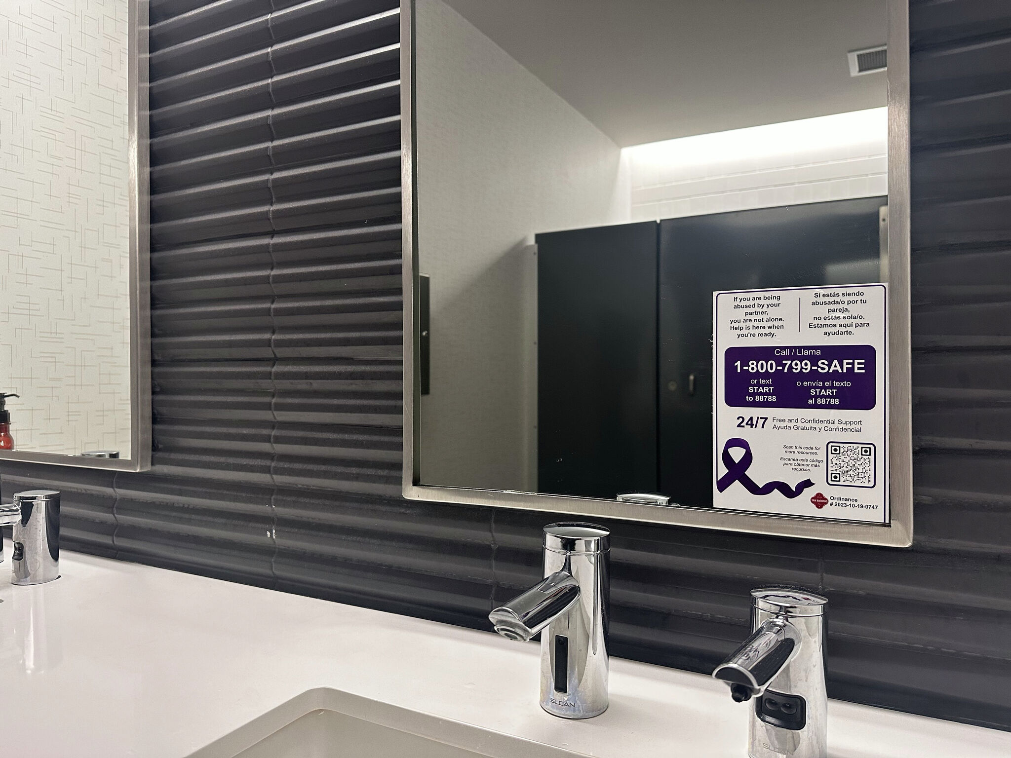 Decal on a restroom mirror is a domestic violence lifeline