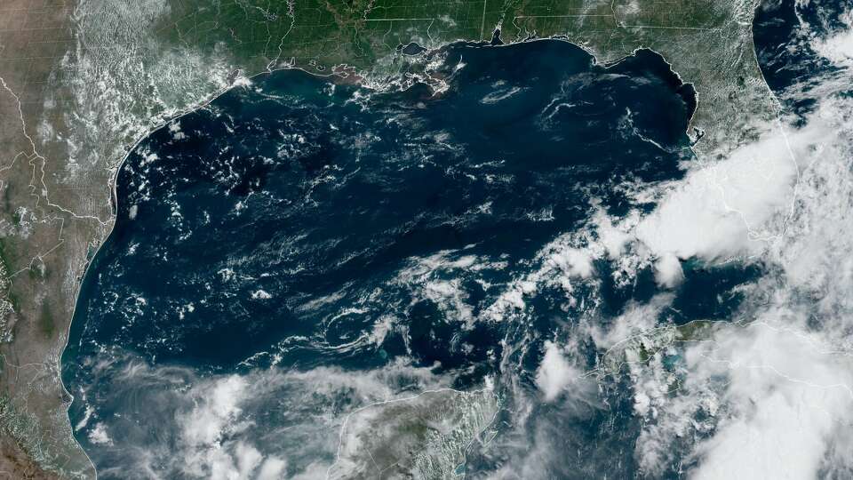 Shown is visible satellite aboard the Geostationary Operational Environmental Satellite, or GOES, taken Thursday afternoon over the Gulf of Mexico. Invest 90L can be seen near Florida, but a second area to watch in the Bay of Campeche could develop into a tropical depression next week.