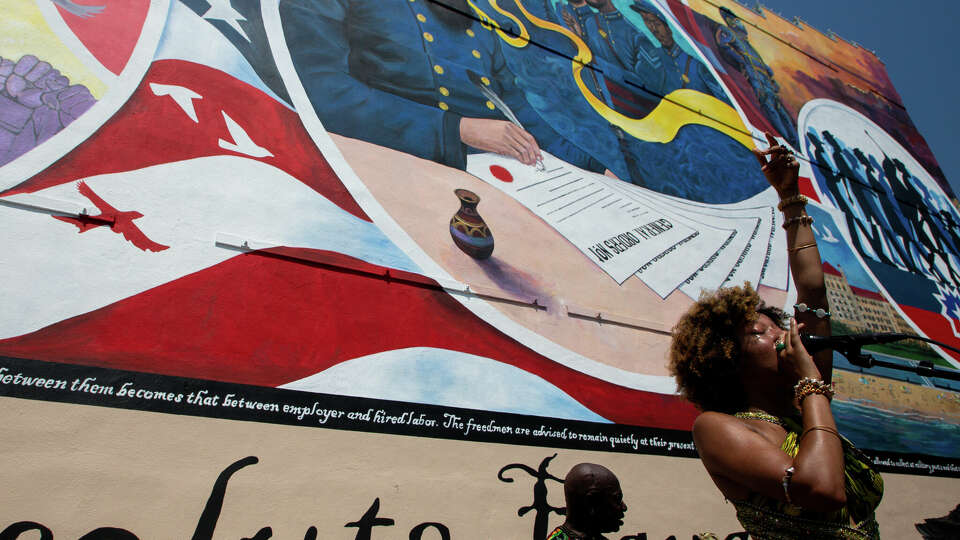 Singer Prescylia Mae performs for a crowd attending the dedication ceremony of the Absolute Equality mural – which was is part of the Juneteenth Legacy Project – on Saturday, June 19, 2021, in Galveston.