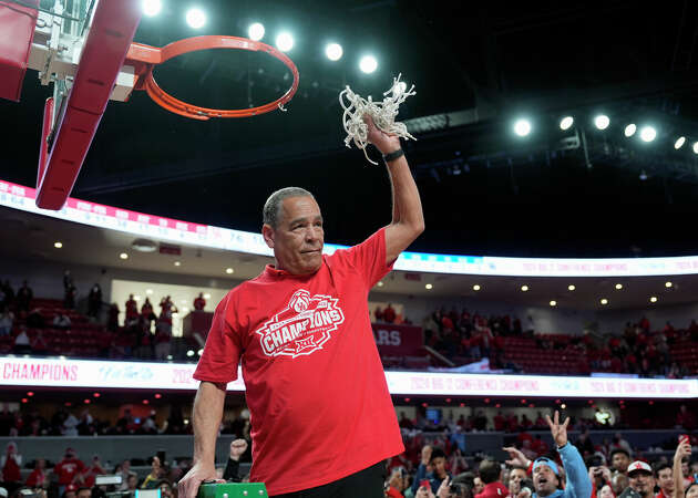 Houston coach Kelvin Sampson cuts down the net after an NCAA college basketball game against Kansas Saturday, March 9, 2024, in Houston.