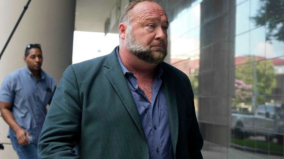 Right-wing conspiracy theorist Alex Jones heads into Bob Casey Federal Courthouse for his bankruptcy hearing Friday, June 14, 2024 in Houston.