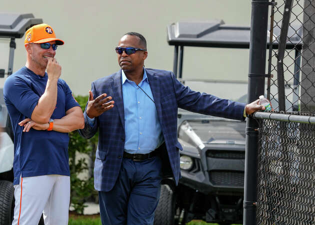 Houston Astros manager Joe Espada (19) and GM Dana Brown chat as they watched pitchers throw off the 10-pack during workouts for Houston Astros pitchers and catchers at CACTI Park of the Palm Beaches on Thursday, Feb. 15, 2024, in West Palm Beach, Florida. 