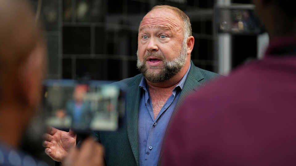 Right-wing conspiracy theorist Alex Jones speaks to the press before his bankruptcy hearing Friday, June 14, 2024 at Bob Casey Federal Courthouse in Houston.