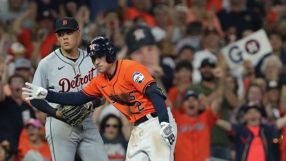 Houston Astros third base Alex Bregman (2) signals on third after hitting an RBI triple against the Detroit Tigers at Minute Maid Park on Friday, June 14, 2024 in Houston.