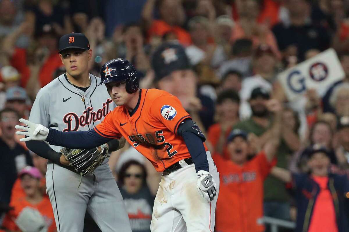 Houston Astros third base Alex Bregman (2) signals on third after hitting an RBI triple against the Detroit Tigers at Minute Maid Park on Friday, June 14, 2024 in Houston.