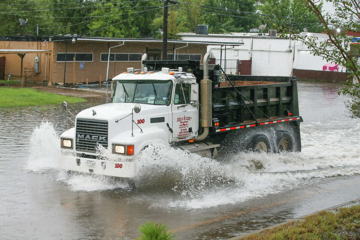 A dump truck drives through the feeder flood waters off of U.S. 59 North during Tropical Depression Imelda on September 19, 2019 in Houston, Texas. 