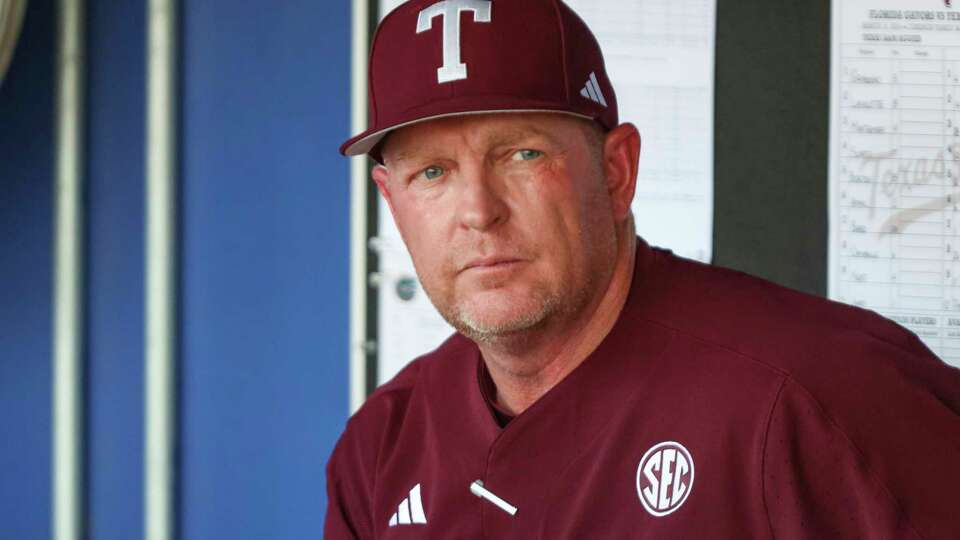 FILE -Texas A&M head coach Jim Schlossnagle watches warm-ups before an NCAA baseball game against Florida on Saturday, March 16, 2024, in Gainesville, Fla. A social media video of Georgia's Christian Mracna's activity in the bullpen and during a dominant performance on the mound in a game on Saturday, April 27, 2024 at top-ranked Texas A&M has led Aggies coach Jim Schlossnagle to suspect the pitcher was putting a foreign substance on the ball in violation of the rules.(AP Photo/Gary McCullough, File)