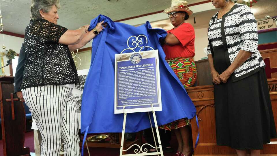 Members of the Montgomery County Historical commission including Annette Kerr, from left, Deborah Hollimon Willams and Julia Leveston reveal a photo of a historical marker for at Lone Tamina Sweet Rest Cemetery on Saturday, June 15, 2024 in Conroe.