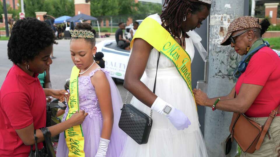 Junior Miss Juneteenth London Lampkin, left, and Miss Juneteenth Destiny Okonkwo, gets help with their sashes before the parade on Saturday, June 15, 2024 in Houston. on Saturday, June 15, 2024 in Houston.