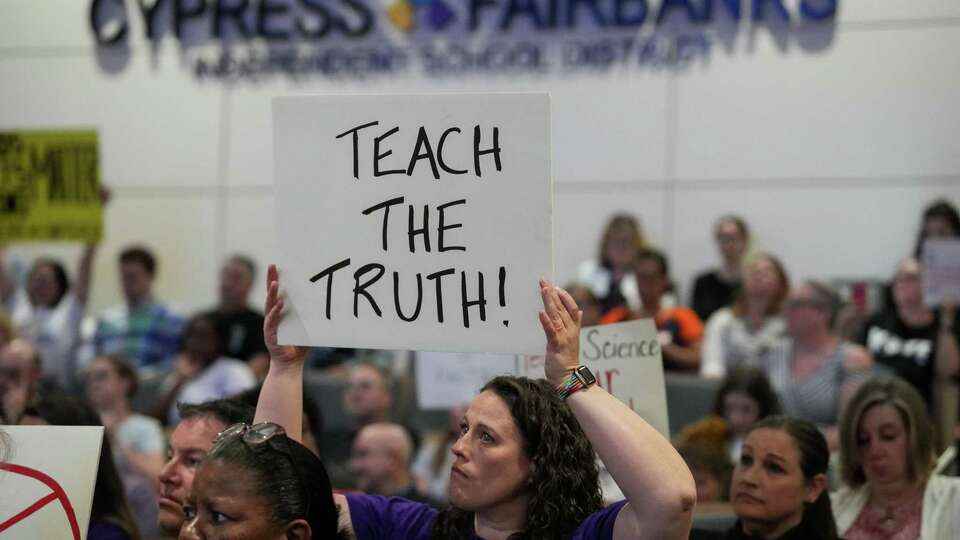 Christina Milan, a parent with two children attending Cypress-Fairbanks ISD schools, protests during a CFISD Board of Trustees meeting Monday, June 17, 2024, at Mark Henry, Ed.D. Administration Building in Cypress. 