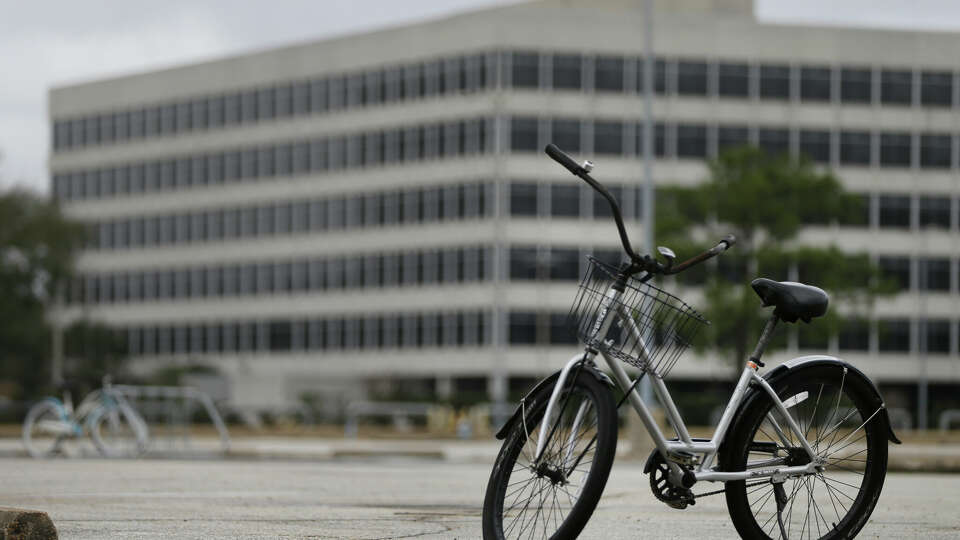 Bicycles used by employees sit in an emtpy parking lot at NASA Johnson Space Center along NASA Road 1 Sunday, Jan. 21, 2018, in Houston. NASA is one of the many government departments and offices hit by the government shutdown.