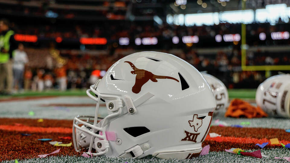 A Texas Longhorns helmet sits on the turf after the Big 12 Championship game between the Texas Longhorns and the Oklahoma State Cowboys on December 2, 2023 at AT&T Stadium in Arlington, Texas.