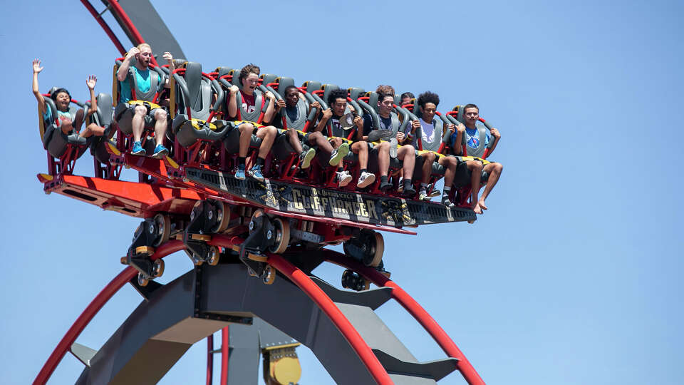 Visitors to Six Flags Fiest Texas take a ride on Dr. Diabolical's Cliffhanger, which Six Flags calls the world's steepest dive coaster, opened in 2022.