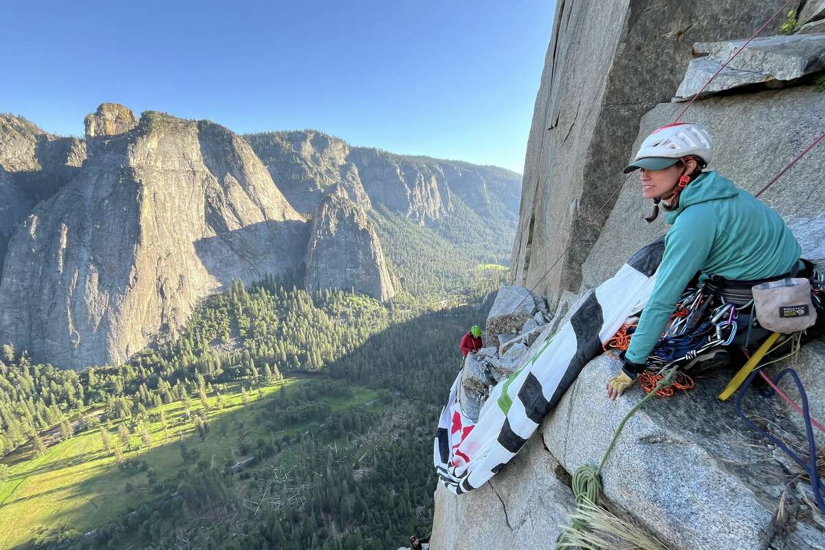 Miranda Oakley, a co-founder of Climbers With Palestine, hangs the banner on El Capitan in Yosemite on June 17, 2024.