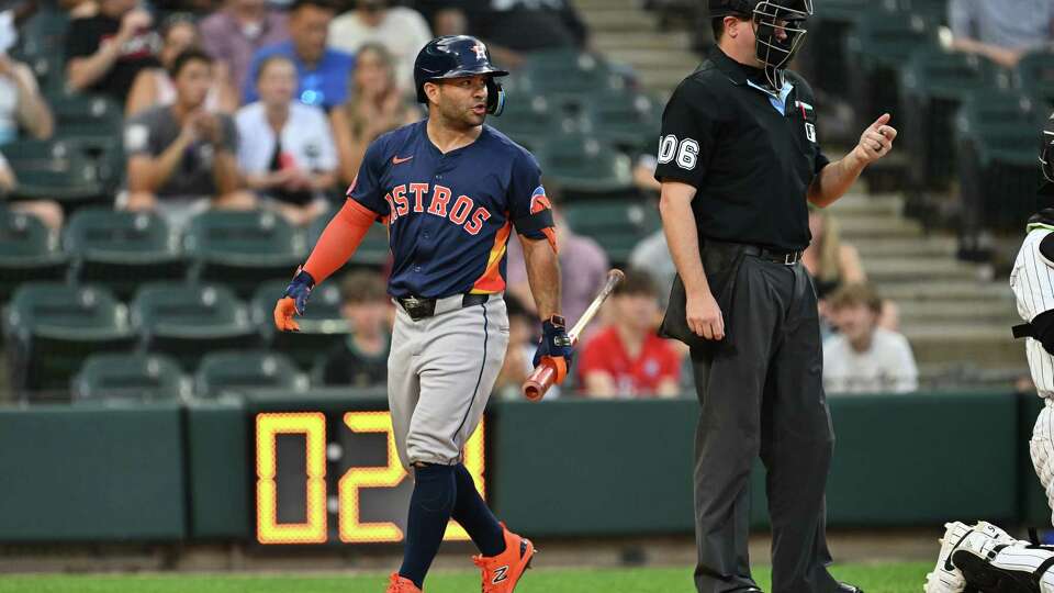 CHICAGO, IL - JUNE 18: Jose Altuve #27 of the Houston Astros speaks to umpire Derek Thomas #106 after striking out in the third inning against the Chicago White Sox at Guaranteed Rate Field on June 18, 2024 in Chicago, Illinois.