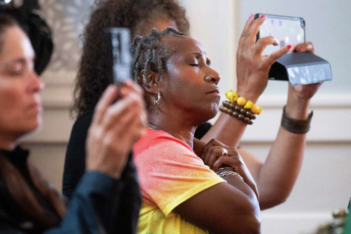 Rose Caballero closes her eyes as she takes in the reading of the Juneteenth proclamation as others video the annual event on their phones at Ashton Villa on Juneteenth, Wednesday, June 19, 2024, in Galveston. The national holiday marks the day in 1865 when news of the Emancipation Proclamation reached Galveston, over two years after it was signed. The event also recognized the effort of former Texas State Representative Albert 'Al' Edwards, known as the architect and father of Juneteenth, for his work to make Juneteenth a federal holiday.