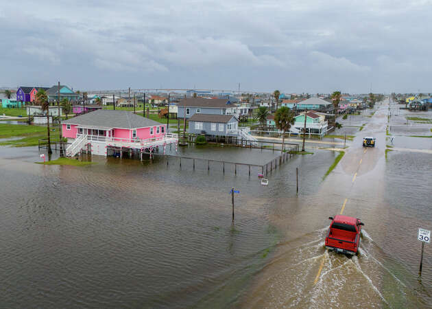 SURFSIDE BEACH, TEXAS - JUNE 19: In an aerial view, vehicles drive through flooded neighborhoods on June 19, 2024 in Surfside Beach, Texas. Storm Alberto, the first named tropical storm of the hurricane season, was located approximately 305 miles south-southeast of Brownsville, Texas and formed earlier today in the Southwestern Gulf of Mexico. The storm has produced heavy winds and rainfall, creating flooding within various communities along Texas coastlines. (Photo by Brandon Bell/Getty Images)