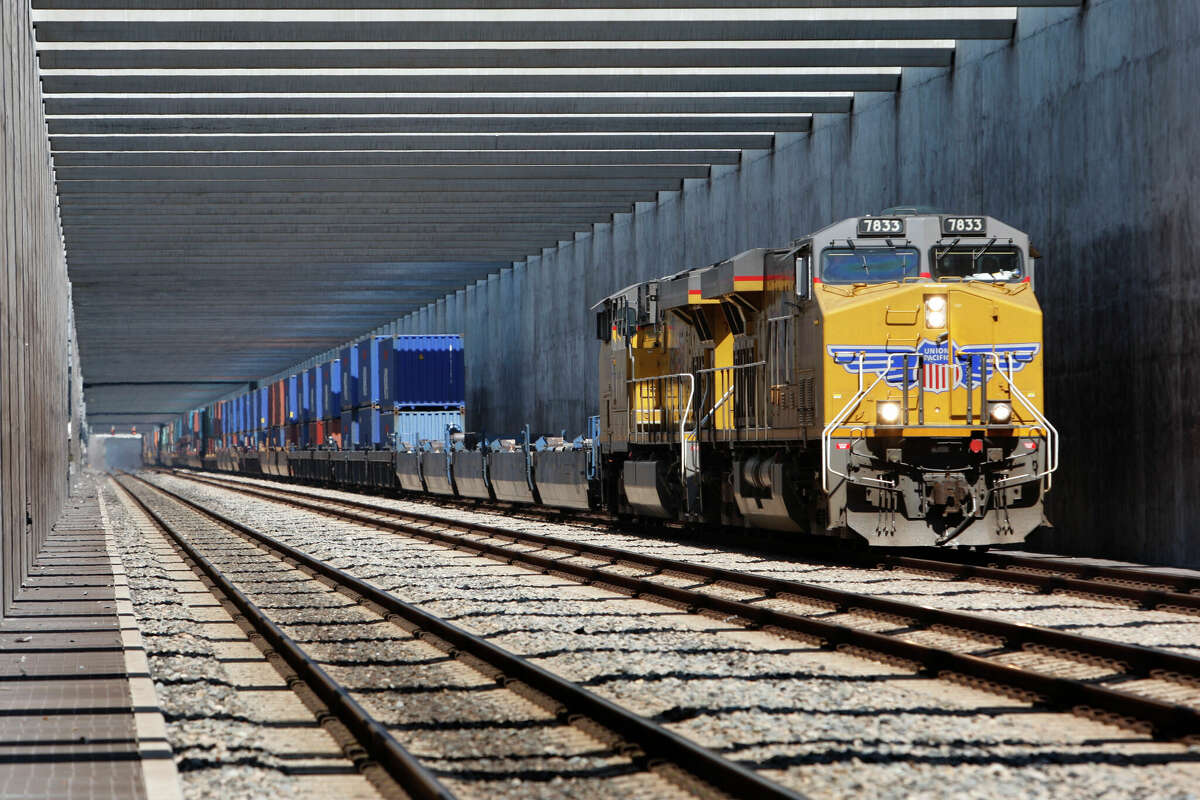 A Union Pacific locomotive pulls a load of containers through Alameda Corridor in Compton, California. The corridor speeds cargo out of the ports of Los Angeles and Long Beach.