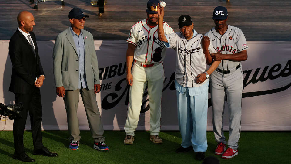 Negro League legend Bill Greason, backed by Derek Jeter, Reggie Jackson, LaMonte Wade Jr., and Willie McGee, throws out the ceremonial first pitch prior to the 2024 Rickwood game between the San Francisco Giants and the St. Louis Cardinals at Rickwood Field on Thursday, June 20, 2024 in Birmingham, Alabama.