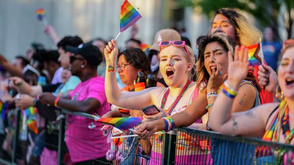 People along the parade route cheer as floats go by during the Pride Parade downtown on Saturday, June 24, 2023 in Houston.