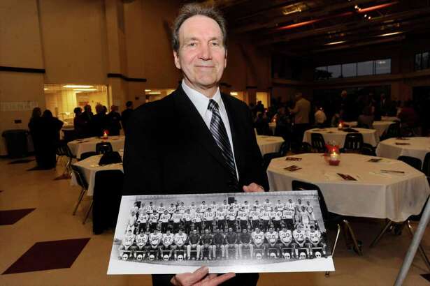 Bridge City Citizen of the Year Steve Worster holds a panoramic photo of the 1967 Cardinals of Bridge City football team. Valentino Mauricio/The Enterprise