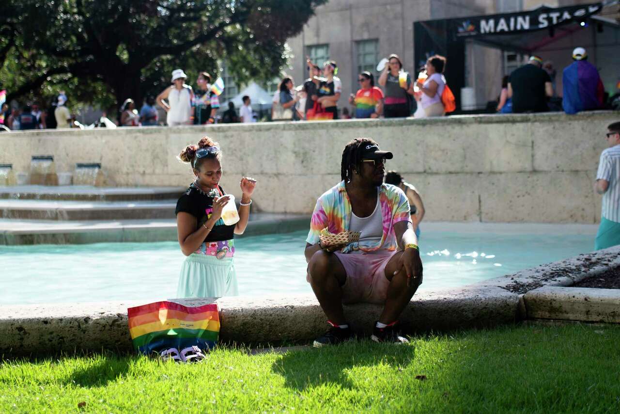 znPeople jump in the pool during the festival before the parade during Houston's New Faces of Pride event, Saturday, June 22, 2024 in Houston.