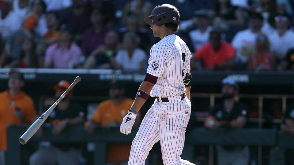 Texas A&M's Kaeden Kent throws his bat after he pops up in the ninth inning for an out against Tennessee during game 2 of the Men's College World Series finals at Charles Schwab field on Sunday, June 23, 2024, in Omaha. A&M lost to Tennessee 4-1 and will play again on Monday night for the NCAA Championship. ( J. Patric Schneider / For the Chronicle )