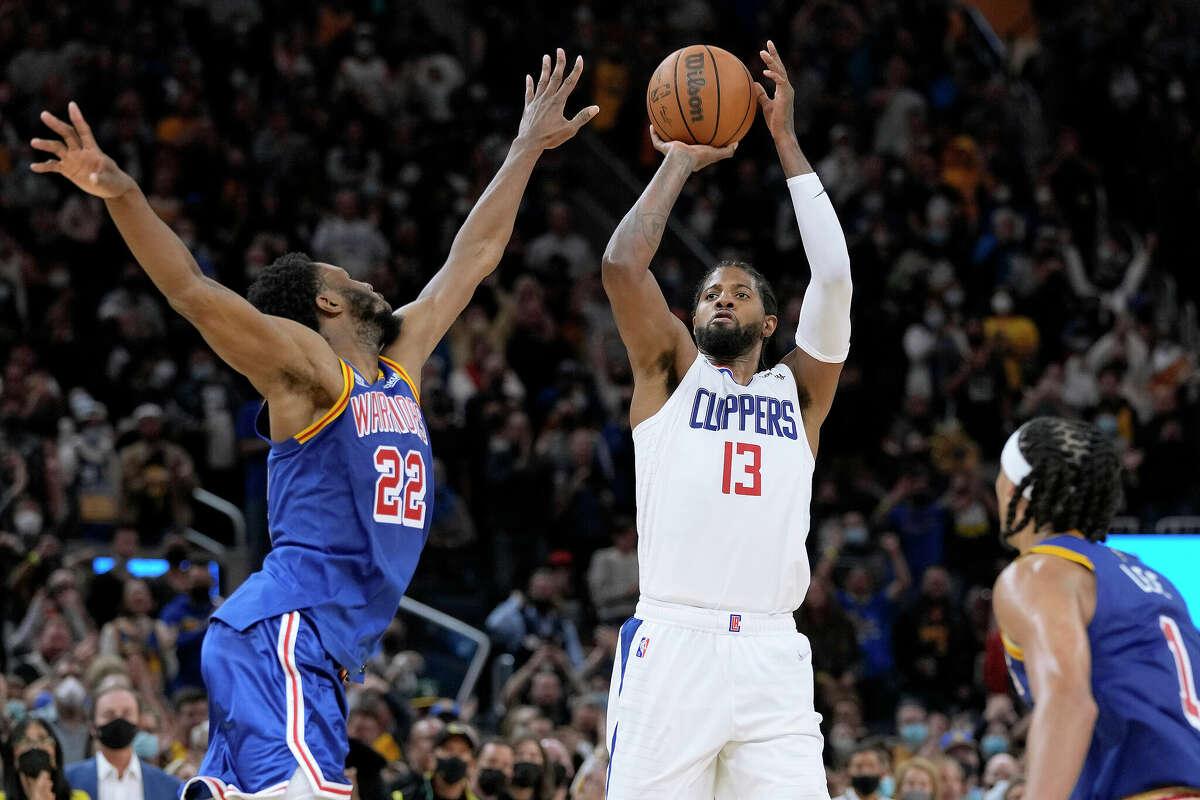 Paul George #13 of the LA Clippers shoots over Andrew Wiggins #22 of the Golden State Warriors during the fourth quarter at Chase Center on Oct. 21, 2021 in San Francisco.