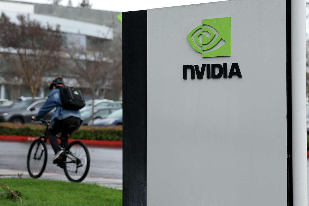 A biker goes past a sign at Nvidia's headquarters in Santa Clara, California on February 05, 2024. The chip company's performance has helped lift the entire stock market this year.