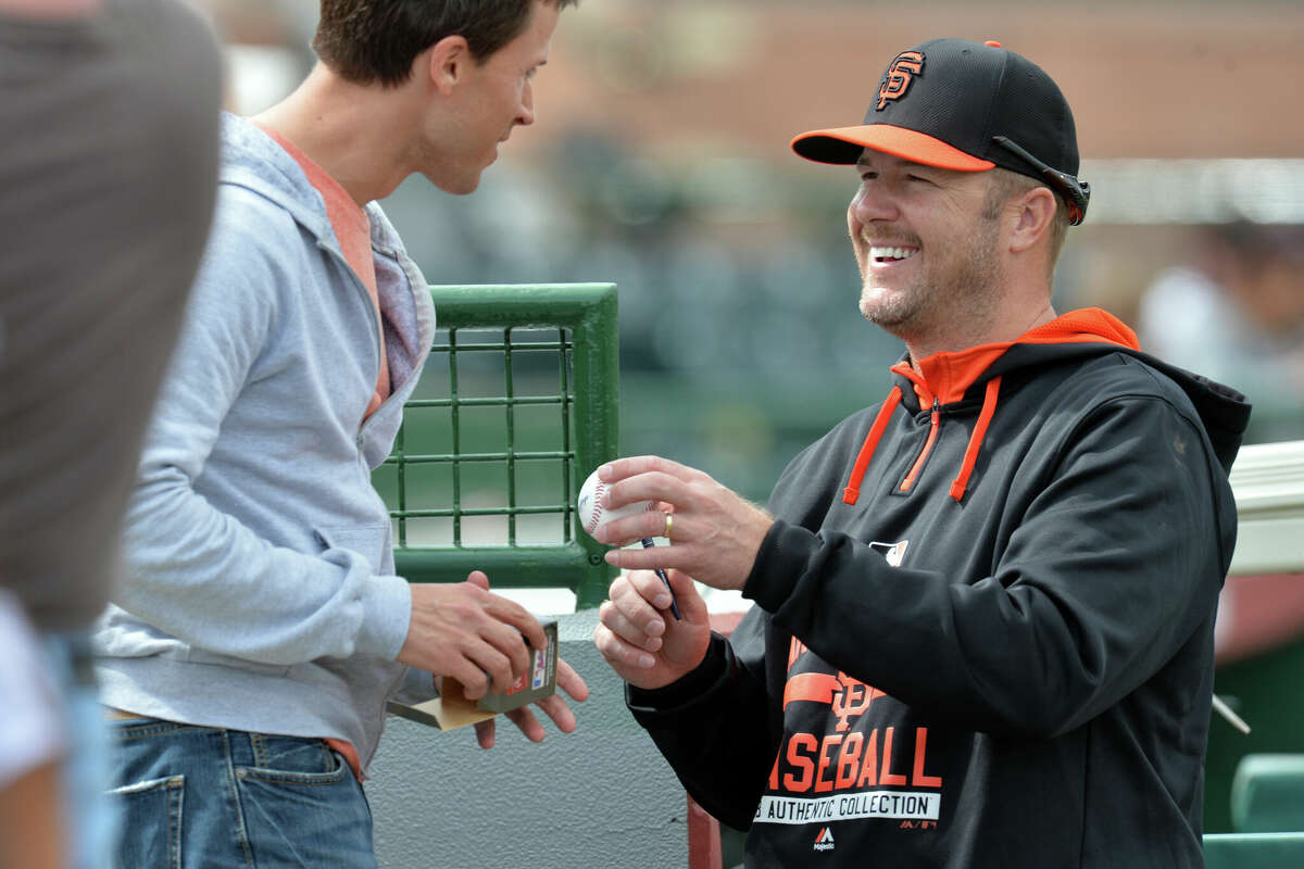 San Francisco Giants coach Jeff Kent signs autographs during spring training at Scottsdale Stadium in Scottsdale Ariz., on March, 1, 2015.