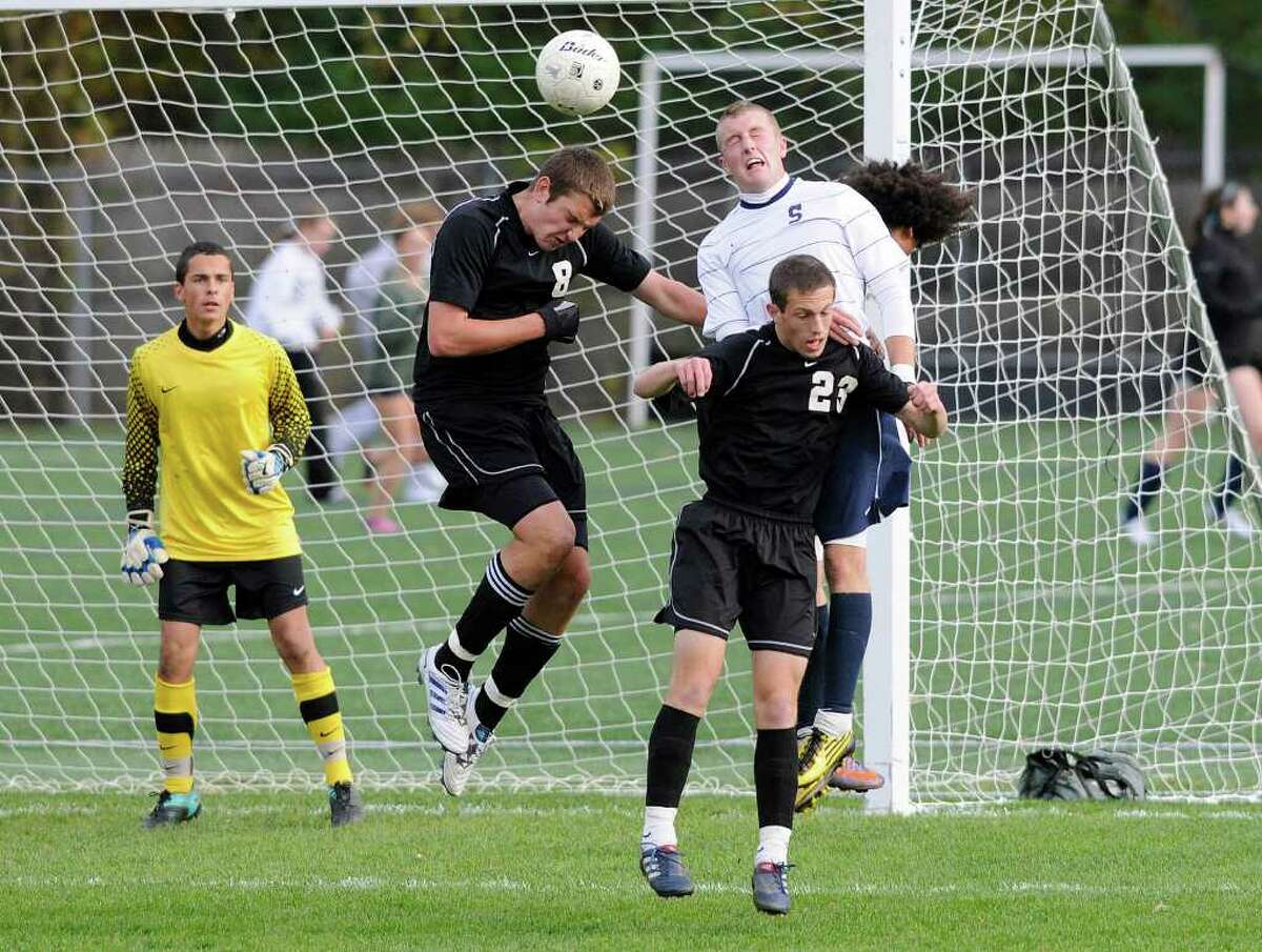 Trumbull's #8 Randy Stratton and #23 Astin Davis and Staples #9 Brendan Lesch go for the header as Staples High School hosts Trumbull High School in soccer in Westport, CT on Friday, October 29, 2010.