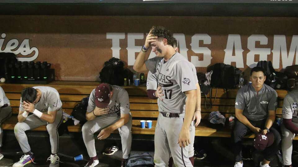 Texas A&M Jace LaViolette (17) and the Aggie baseball team hold back tears after losing to Tennessee 6-5 in game 3 of the Mens College World Series finals against Tennessee at Charles Schwab field on Monday, June 24, 2024, in Omaha.