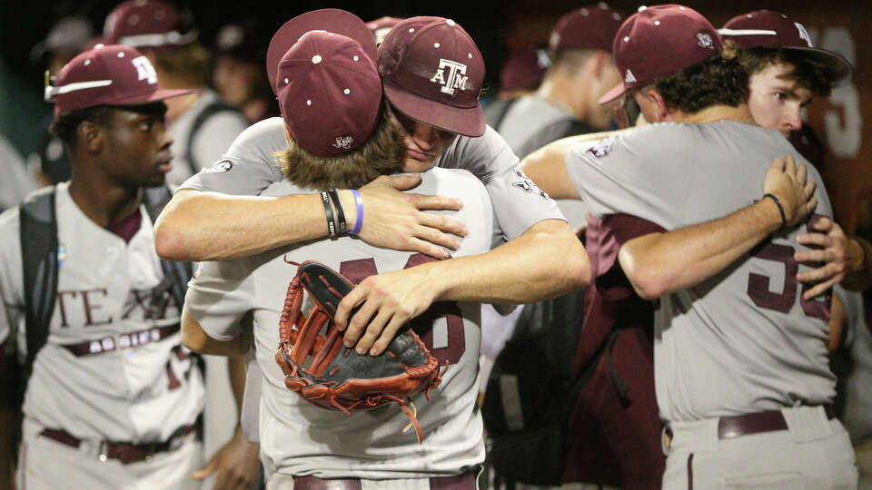 Texas A&M's baseball team console one another after losing to Tennessee 6-5 in game 3 of the Mens College World Series finals at Charles Schwab field on Monday, June 24, 2024, in Omaha. ( J. Patric Schneider / For the Chronicle )