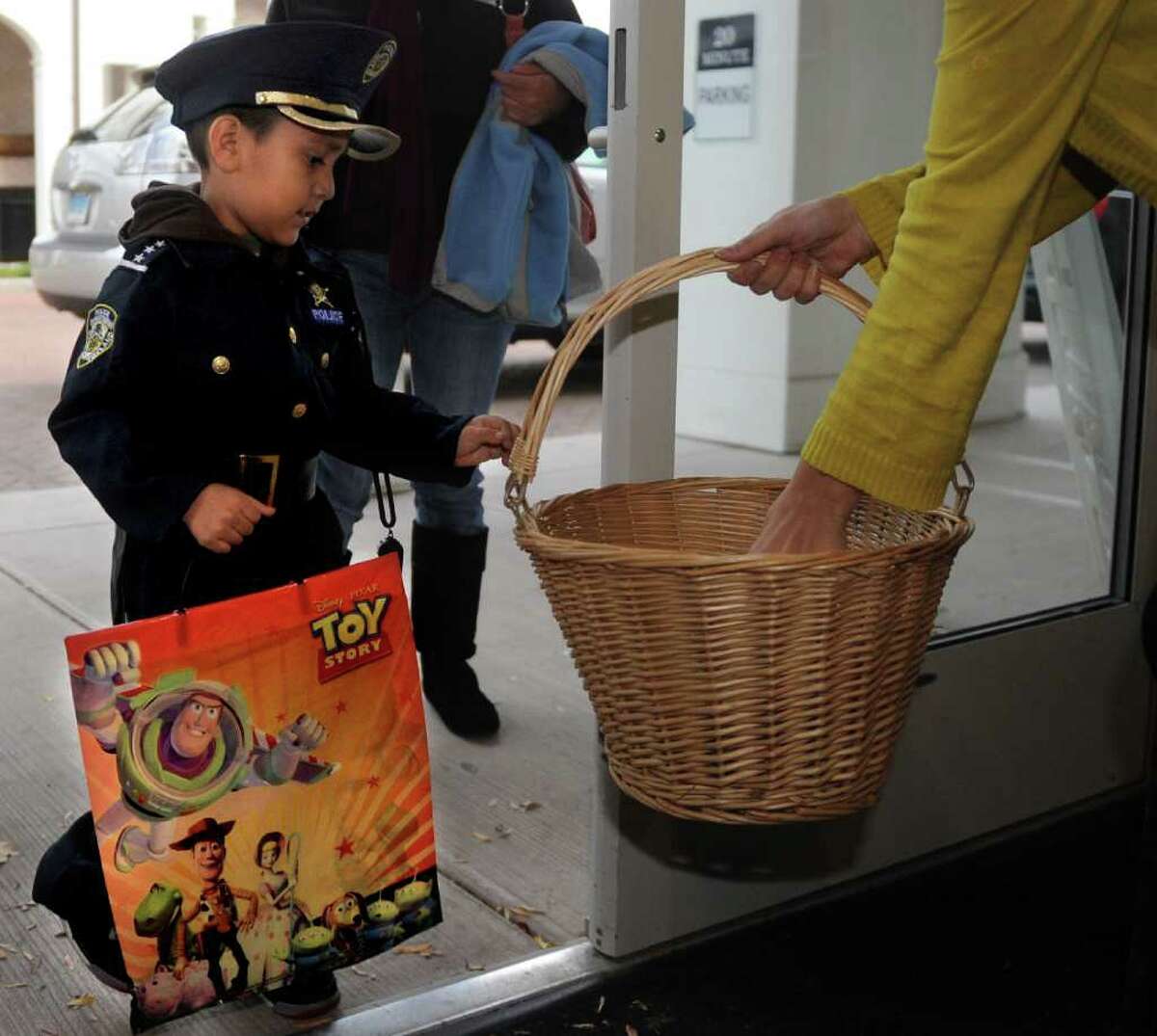 Anthony Luna, 4, gets candy from Minette and Rock during the Trick or Treat on Safety Street event in Fairfield on Friday, October 29, 2010.