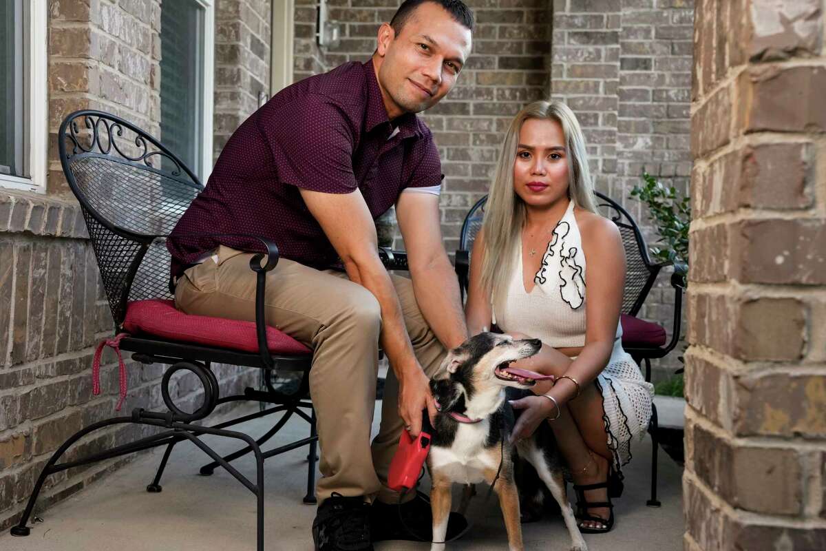 Jennie Tran, 36, and Michael Roth, 40, and their senior dog Sammy pose for a photograph at their patio Monday, June 24, 2024 in Austin. 