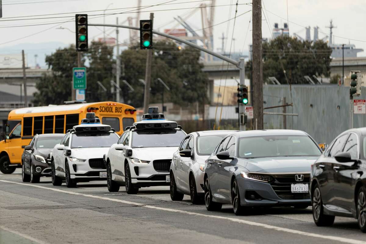 Waymo autonomous vehicles drive in traffic on Cesar Chavez Street in San Francisco, on November 17, 2023.