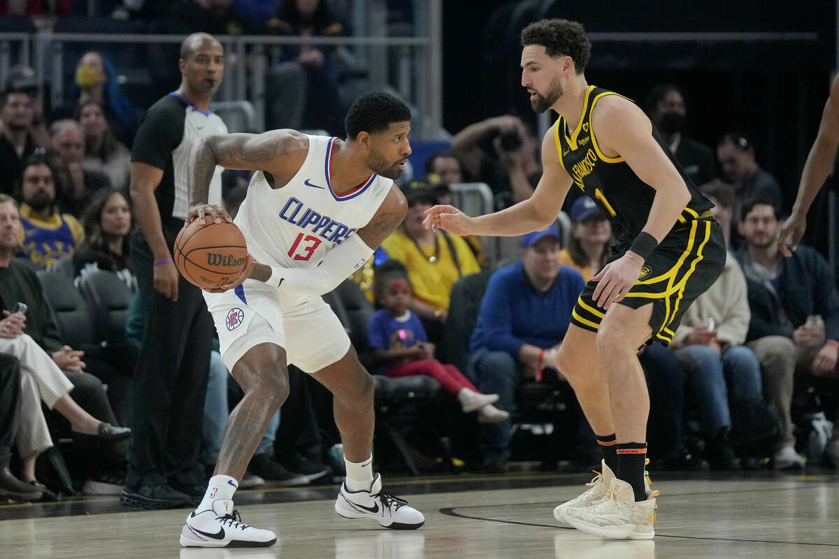 Los Angeles Clippers forward Paul George (13) is defended by Golden State Warriors guard Klay Thompson during an NBA basketball game in San Francisco, Wednesday, Feb. 14, 2024.