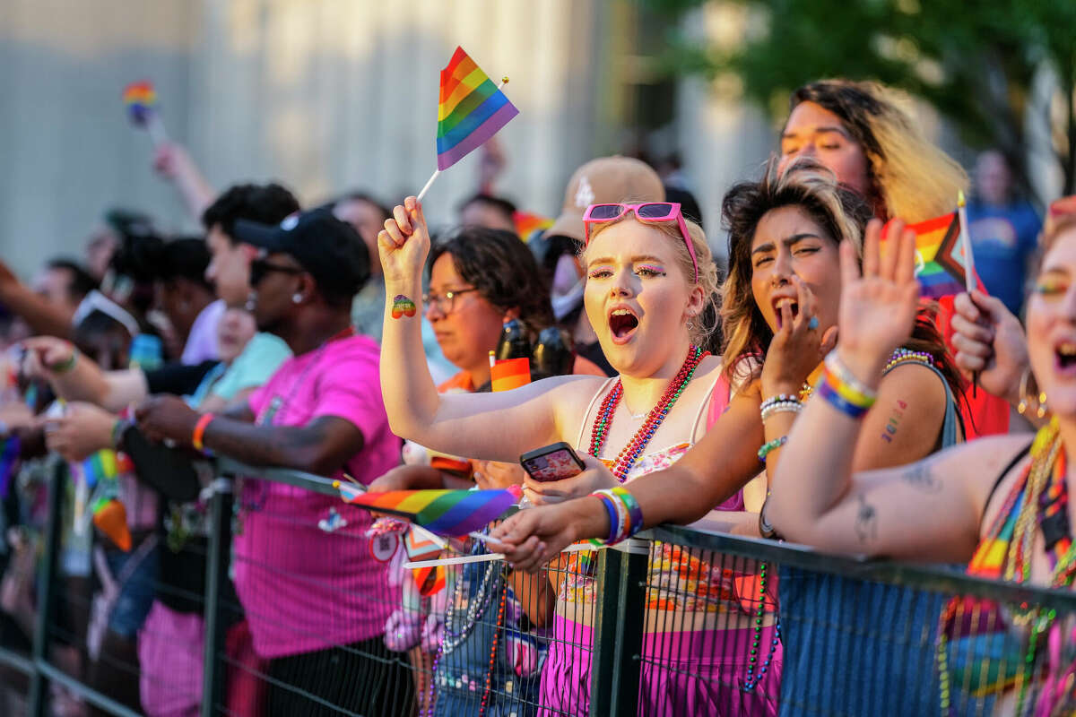 People along the parade route cheer as floats go by during the Pride Parade downtown on Saturday, June 24, 2023 in Houston.