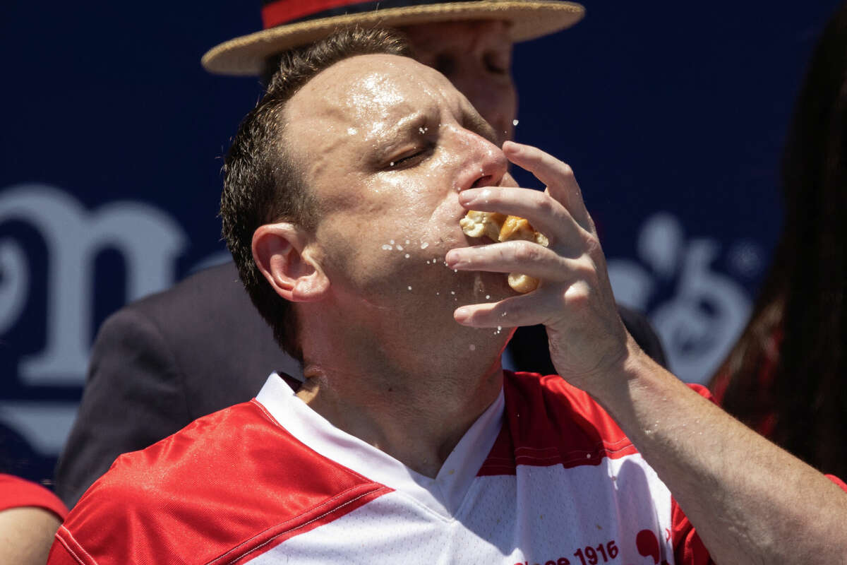 Joey Chestnut eats as he competes for his 15th championship title during the 2022 Nathan's Famous Fourth of July hot dog eating contest on Coney Island on July 4, 2022 in New York. - Joey Chestnut won by eating 63 hot dogs and buns. (Photo by Yuki IWAMURA / AFP) (Photo by YUKI IWAMURA/AFP via Getty Images)