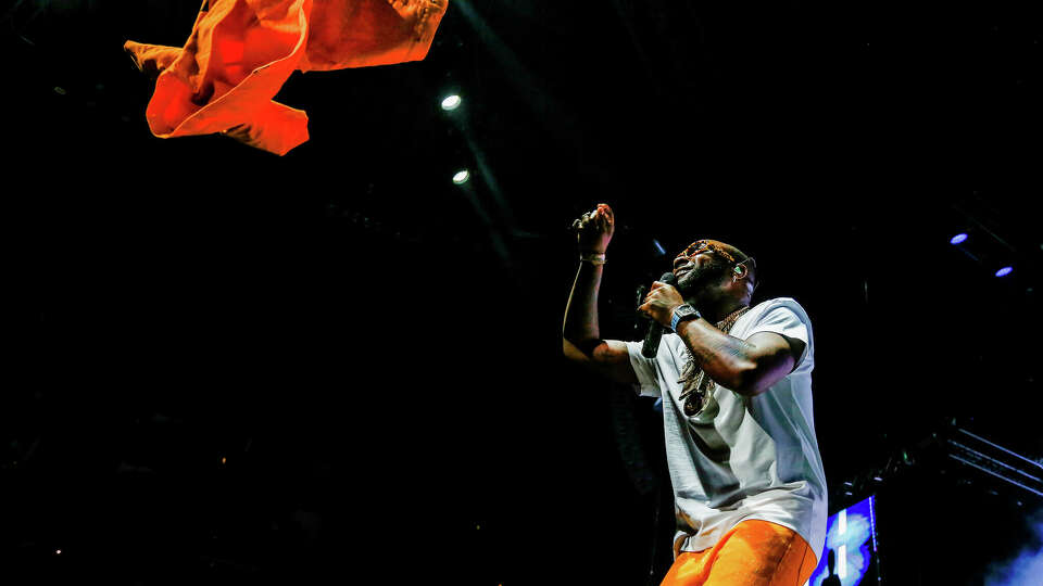 Davido throws his jacket to the crowd as he performs at the Toyota Center on Friday, July 7, 2023 in Houston.