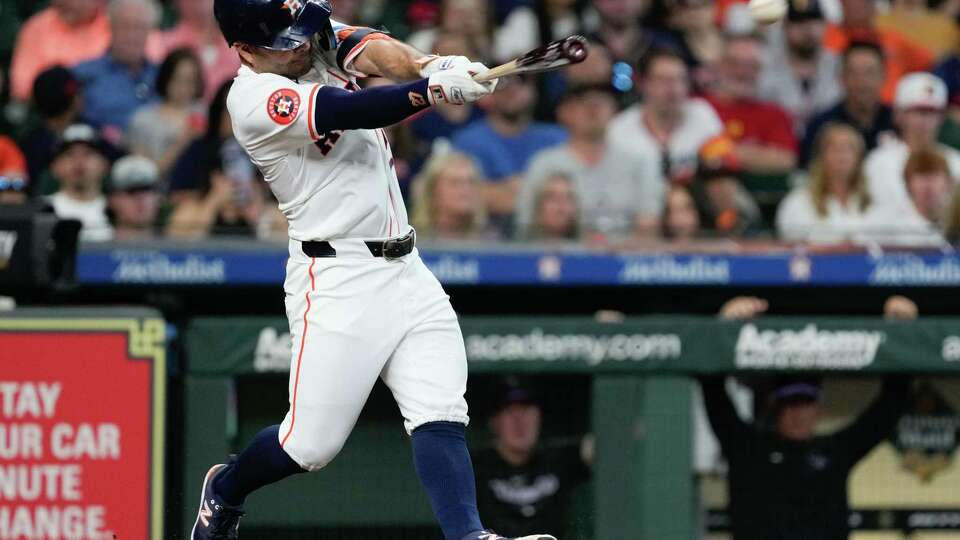 Houston Astros Jose Altuve (27) hits a single off Colorado Rockies starting pitcher Ryan Feltner in the fourth inning of an MLB baseball game at Minute Maid Park, Wednesday, June 26, 2024, in Houston.