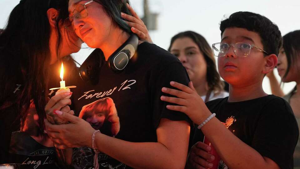 Alexis Nungaray, Jocelyn’s mom, center, is comforted during a candlelight vigil for her daughter on Friday, June 21, 2024 in Houston.